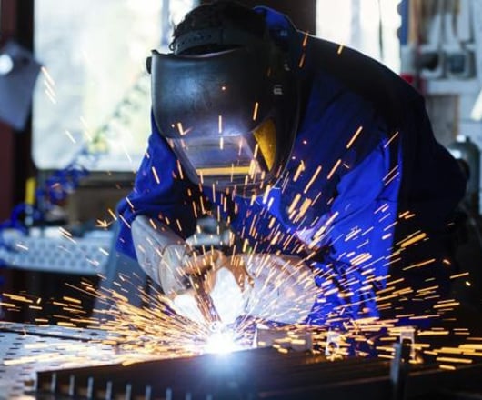 welder-working-with-sparks-flying-in-workshop
